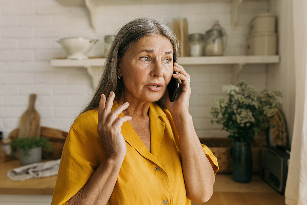 Elder woman talking on the phone.