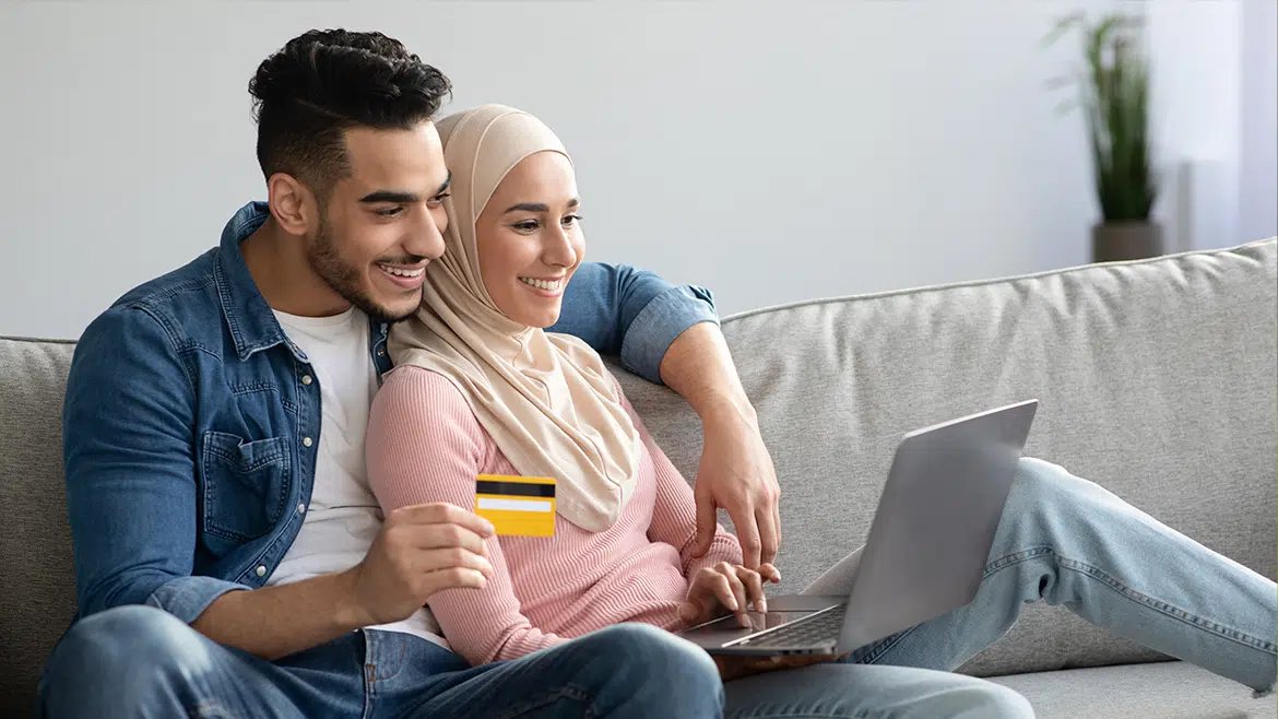 Young Couple using Credit Card on Computer